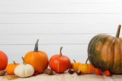 Happy Thanksgiving day. Beautiful composition with pumpkins on wooden table, space for text