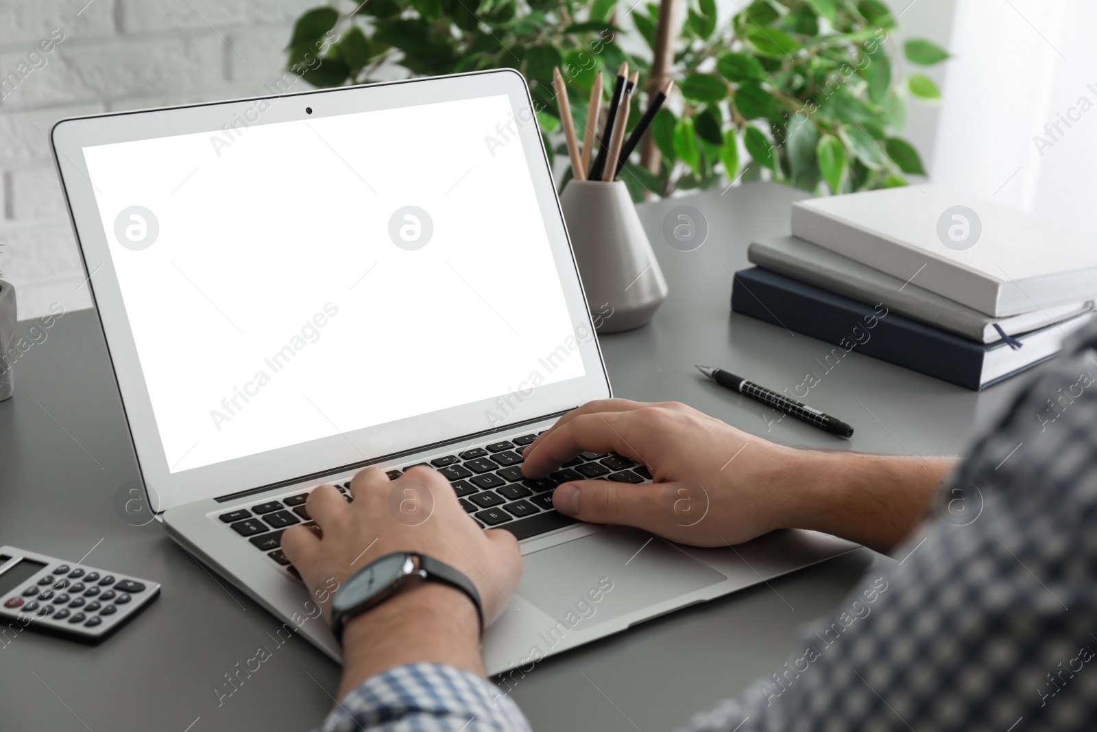 Image of Man working with modern computer at table, closeup. Space for design