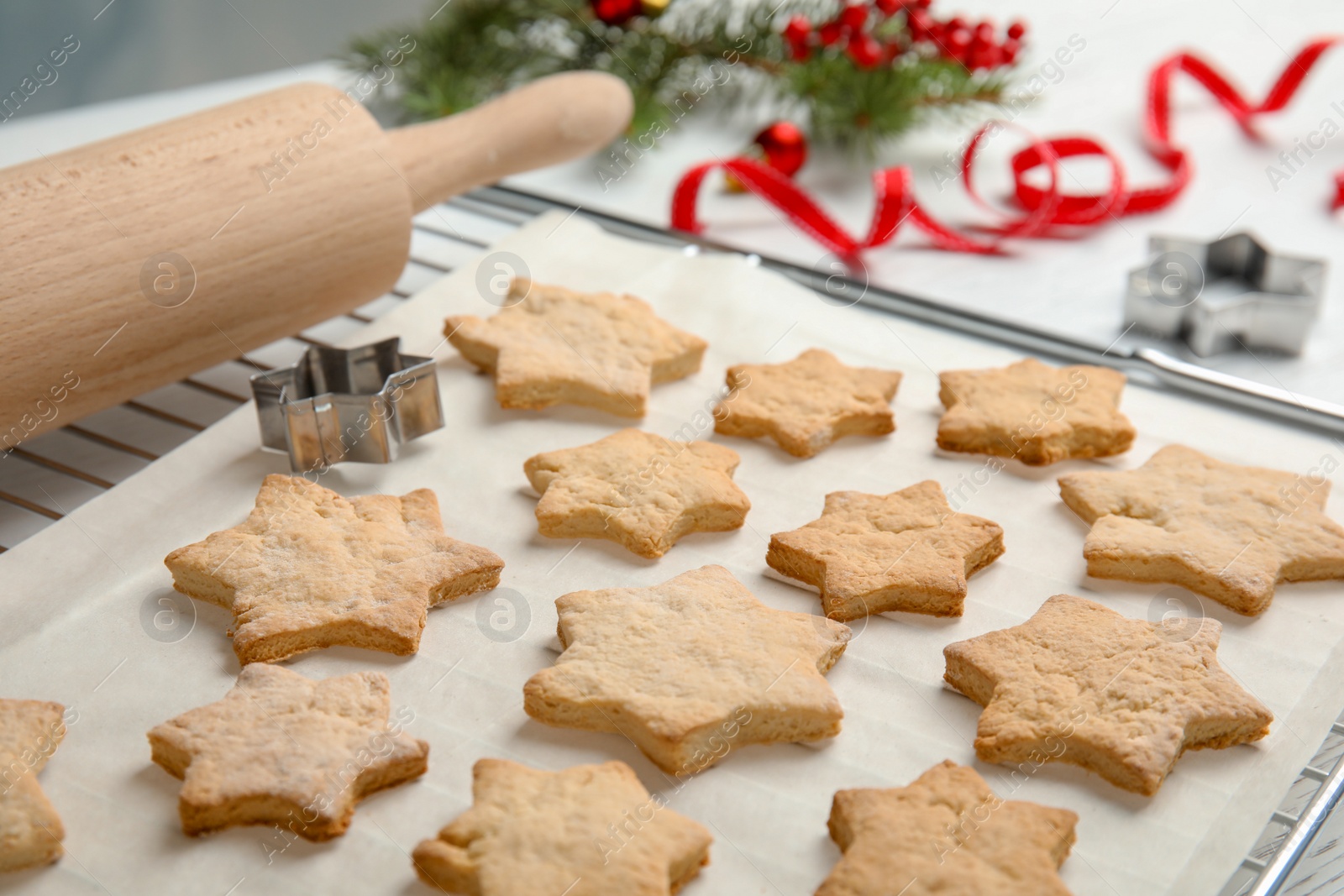 Photo of Tasty homemade Christmas cookies on baking parchment