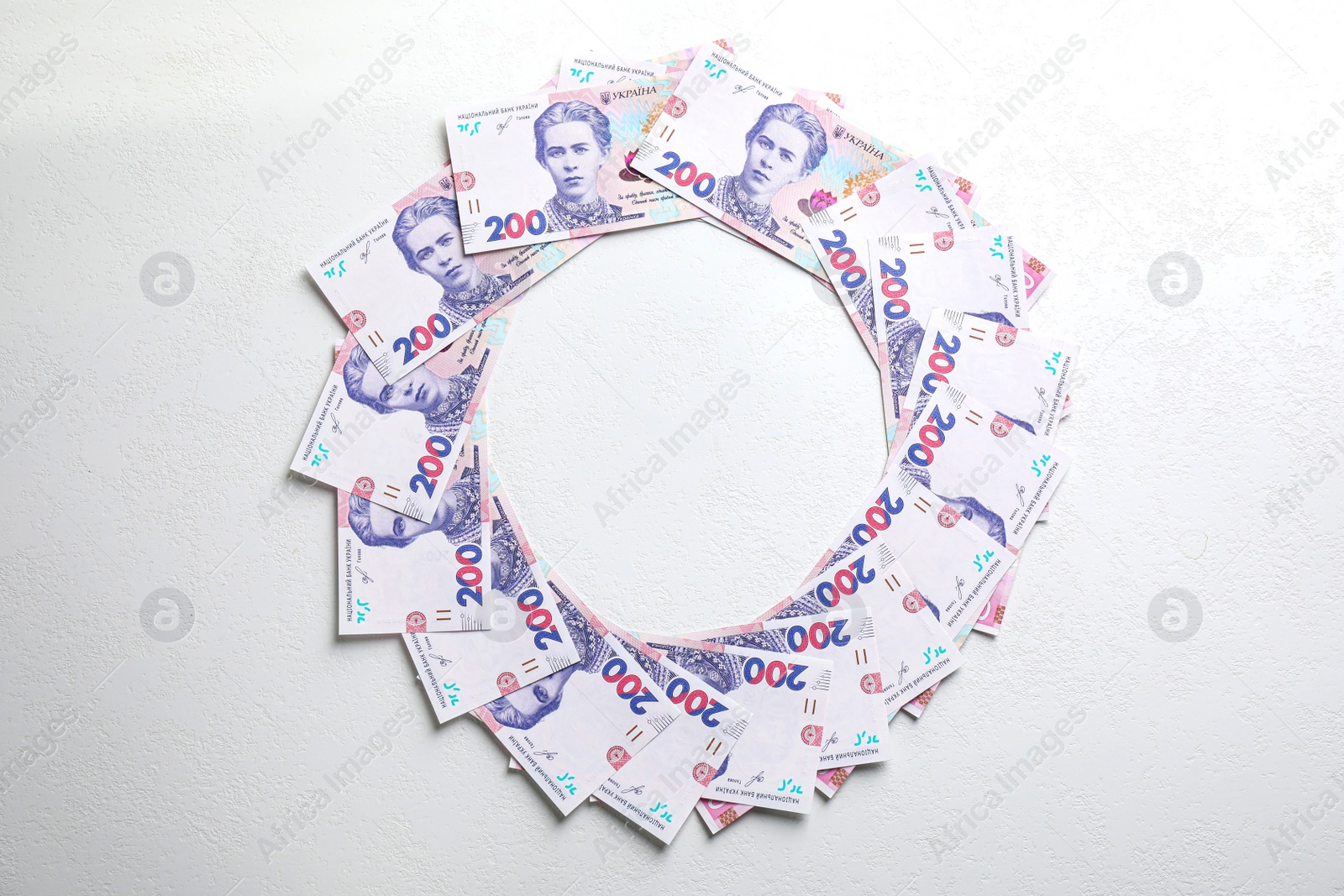 Photo of Frame of Ukrainian money on white background, flat lay. Space for text