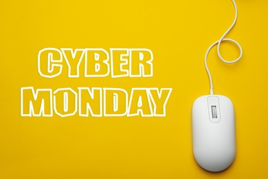 Image of Text Cyber Monday and wired computer mouse on yellow background, top view