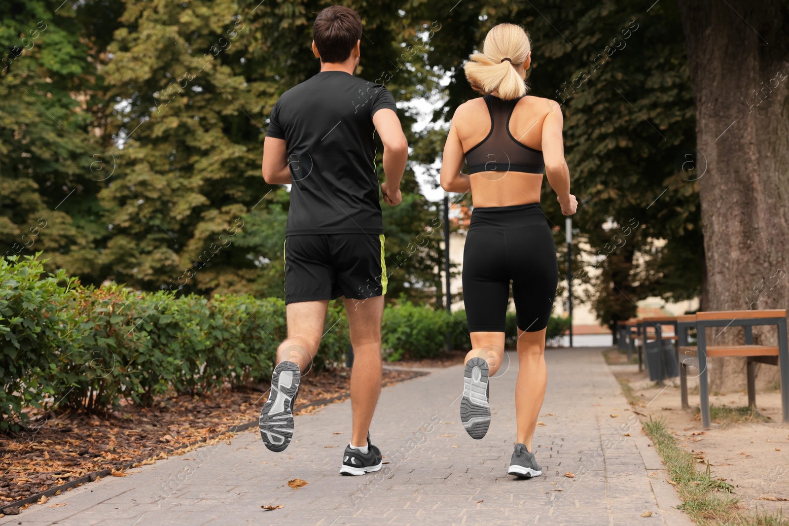 Photo of Healthy lifestyle. Couple running in park, back view