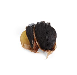 Photo of Cloves of fermented black garlic isolated on white