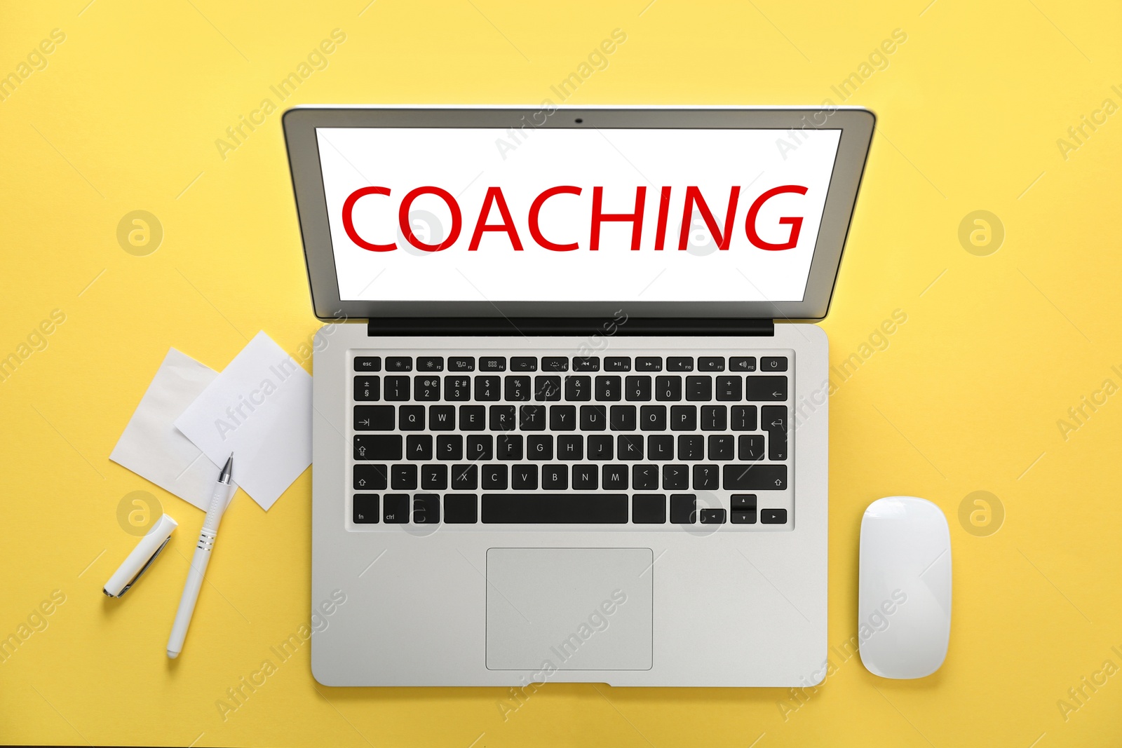 Image of Business training or life coaching. Modern laptop and stationery on yellow background, flat lay