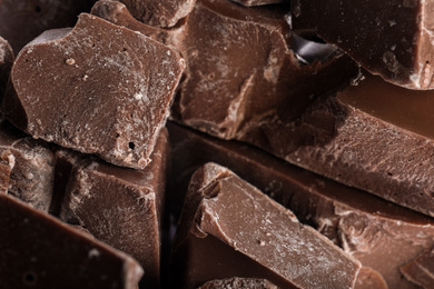 Pieces of milk chocolate as background, closeup