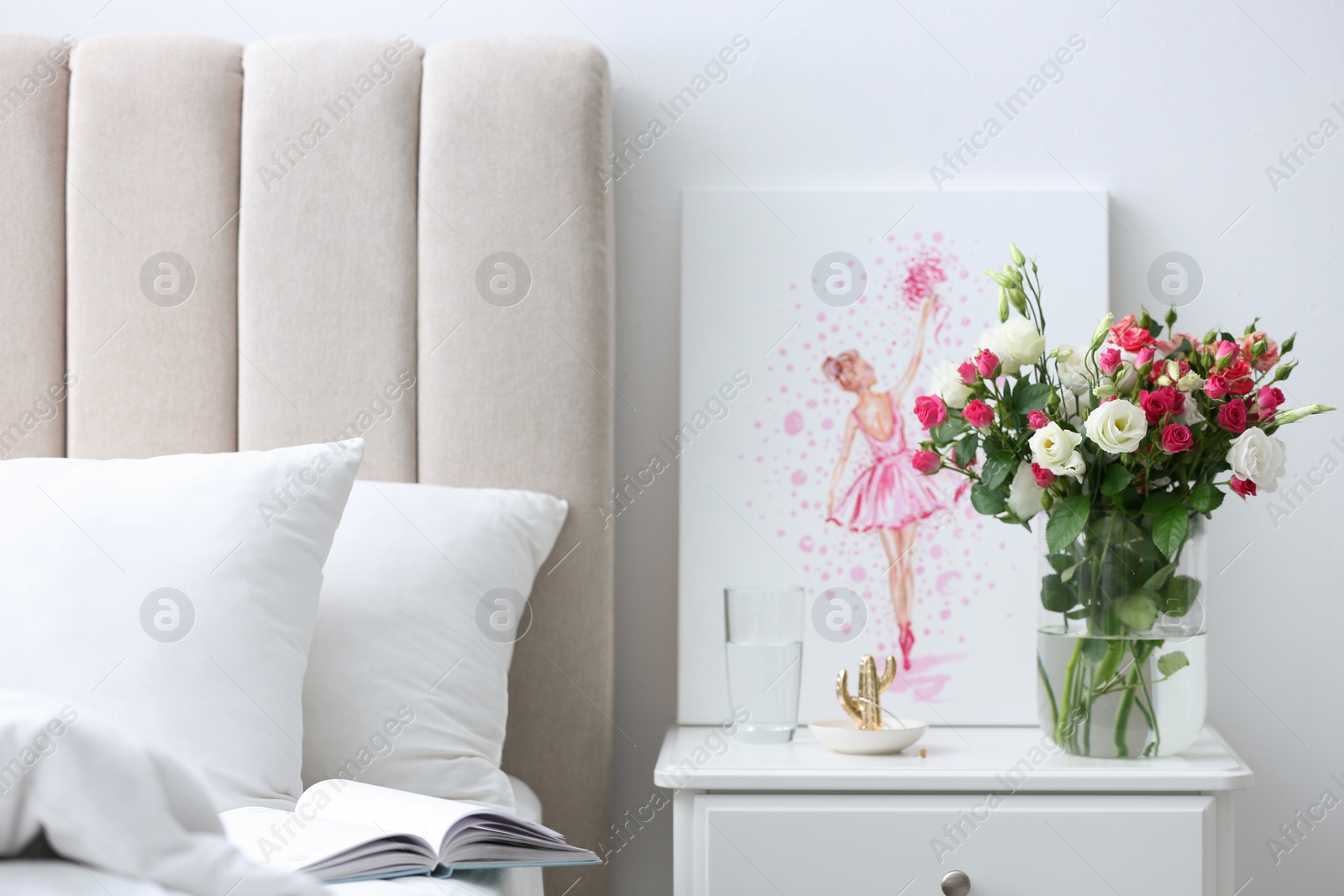 Photo of Glass vase with fresh flowers in bedroom