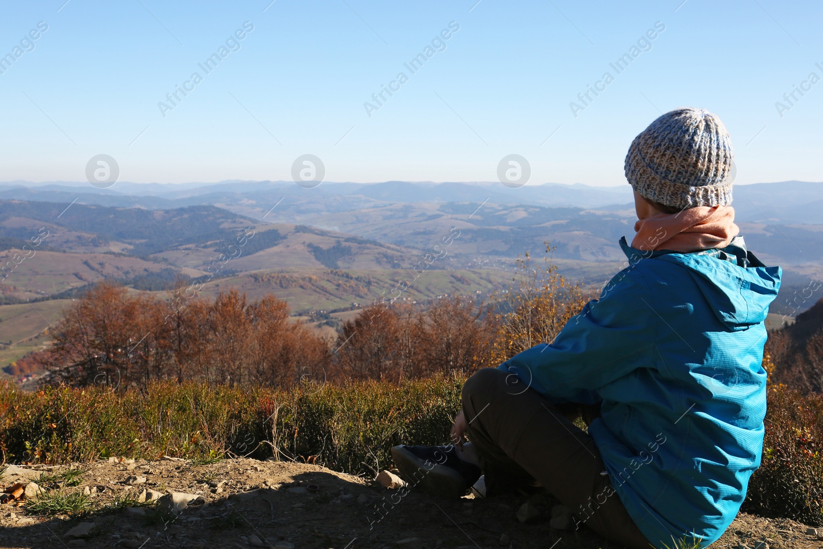 Photo of Woman in warm clothes enjoying mountain landscape