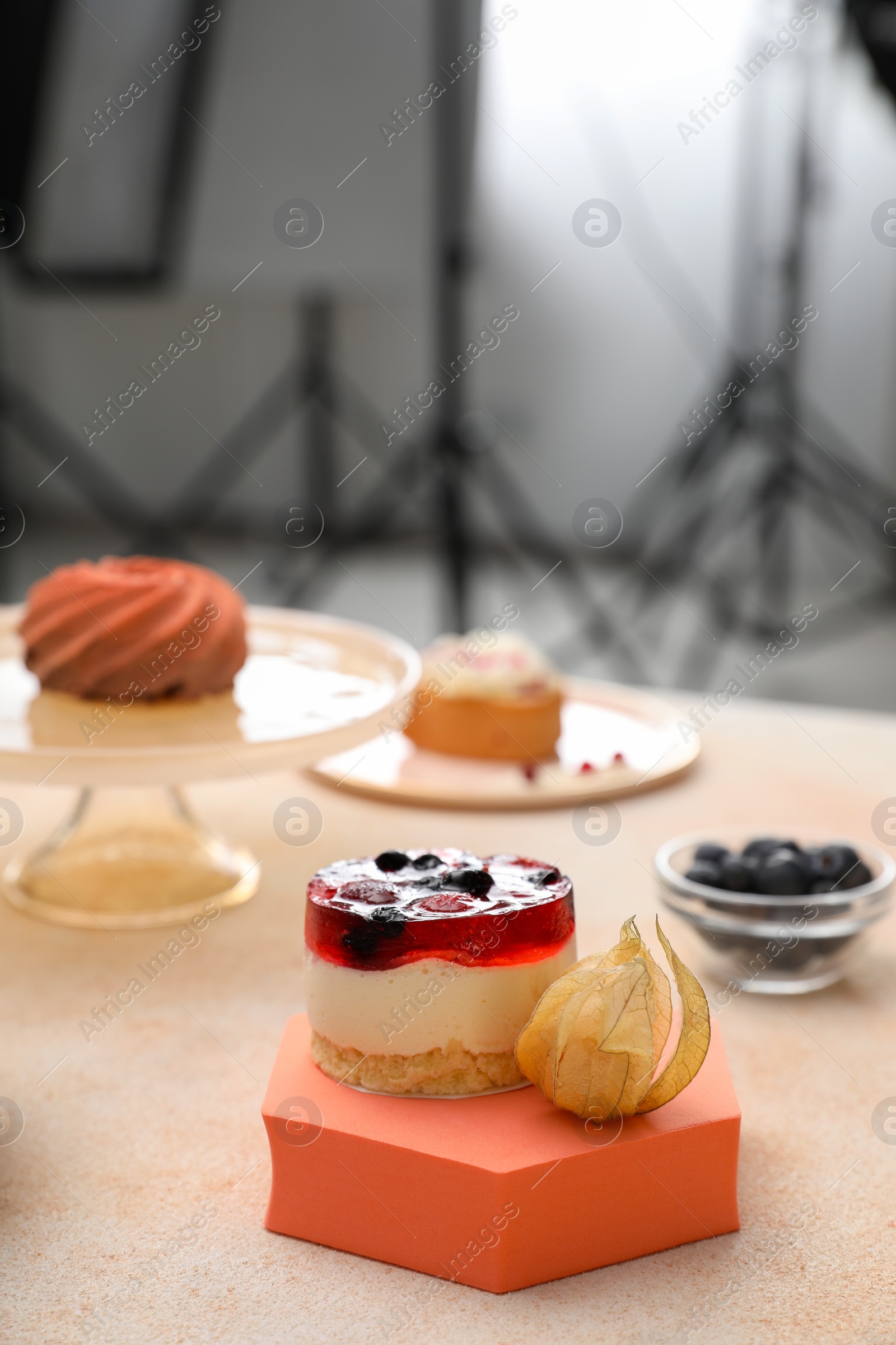 Photo of Professional equipment and composition with delicious dessert on beige table in studio. Food photography