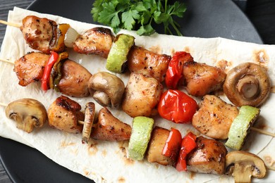 Photo of Delicious shish kebabs with vegetables on table, top view