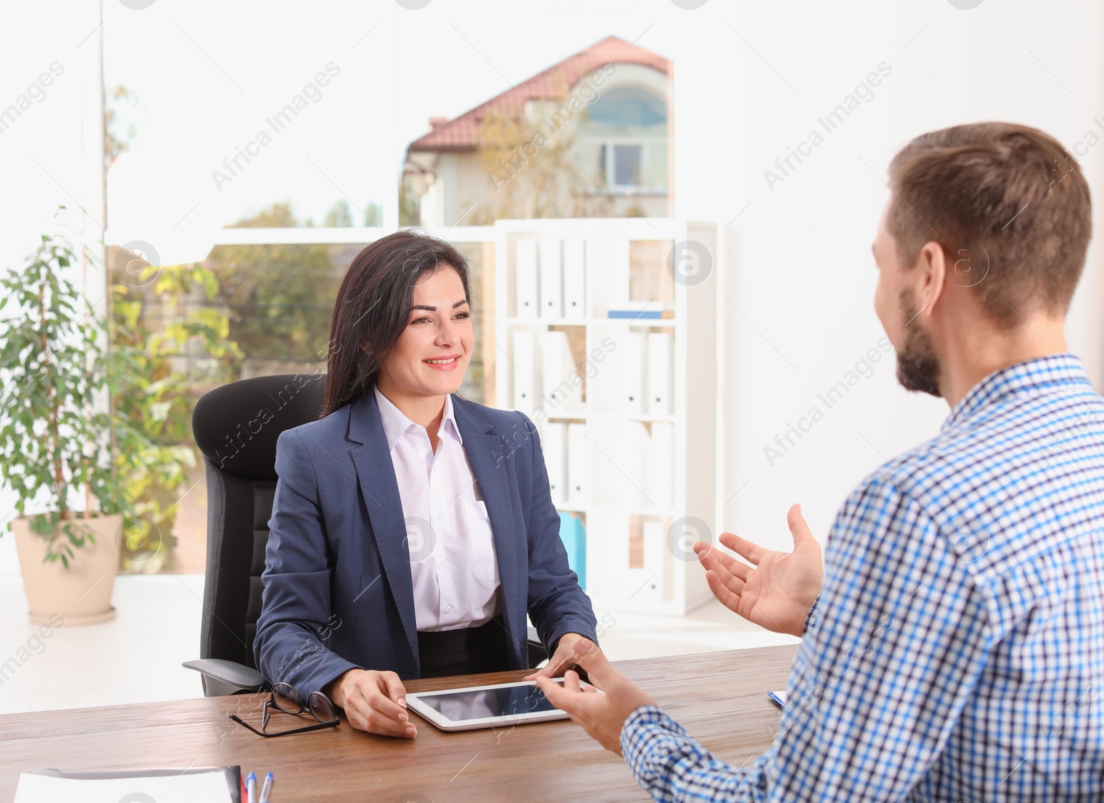 Photo of Human resources manager conducting job interview with applicant in office