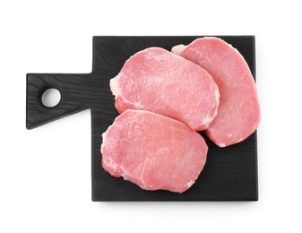 Photo of Black wooden board with pieces of raw pork meat isolated on white, top view