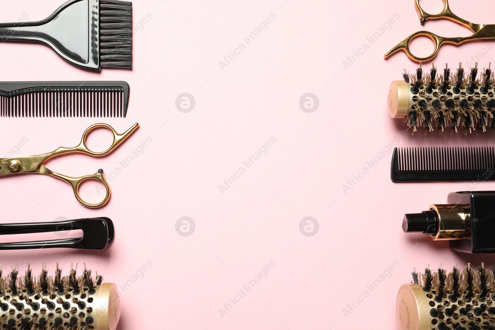 Photo of Professional hair dresser tools on pink background, flat lay. Space for text