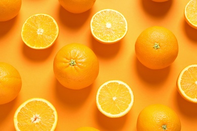 Flat lay composition with ripe oranges on color background