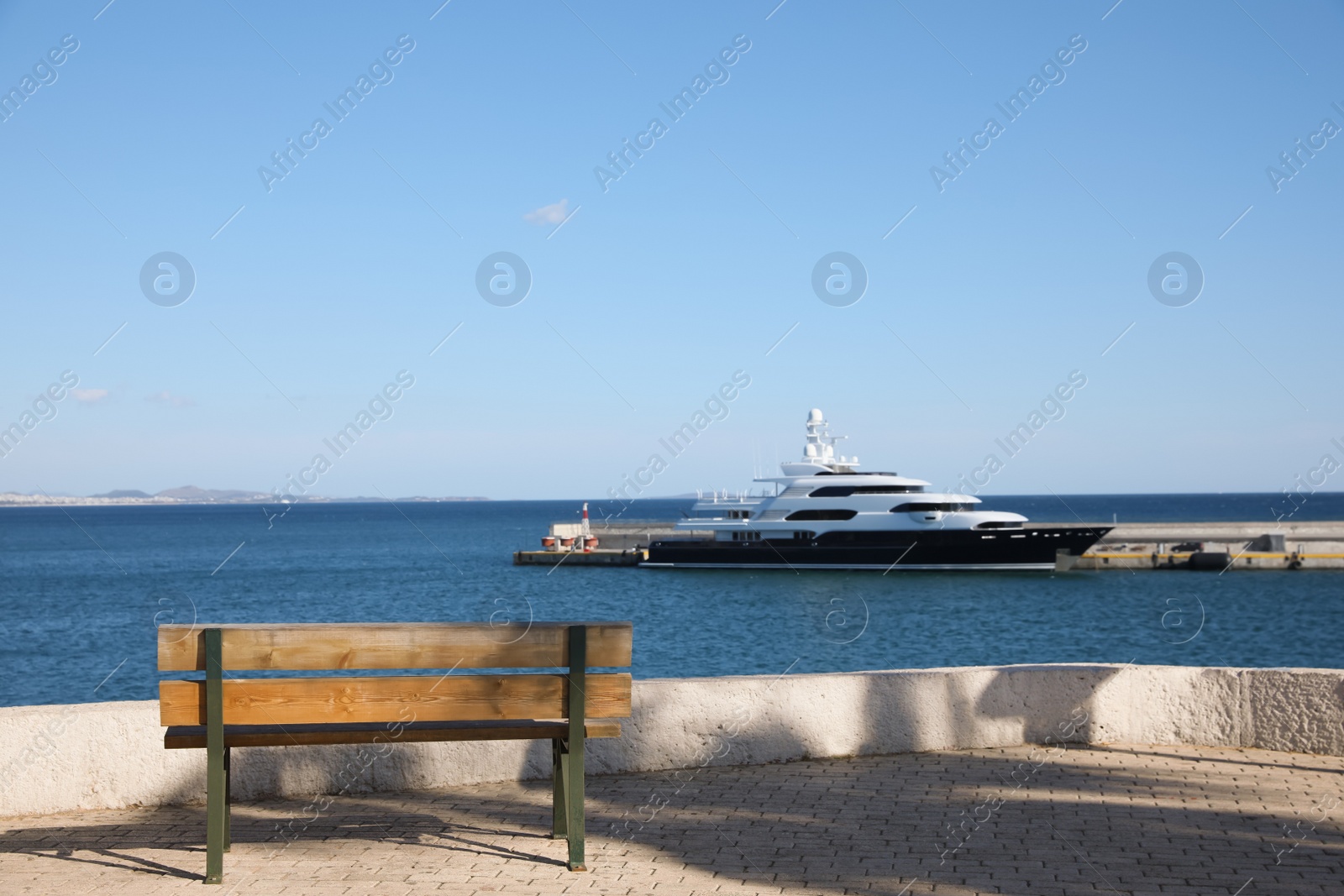 Photo of Wooden bench on pier near sea port