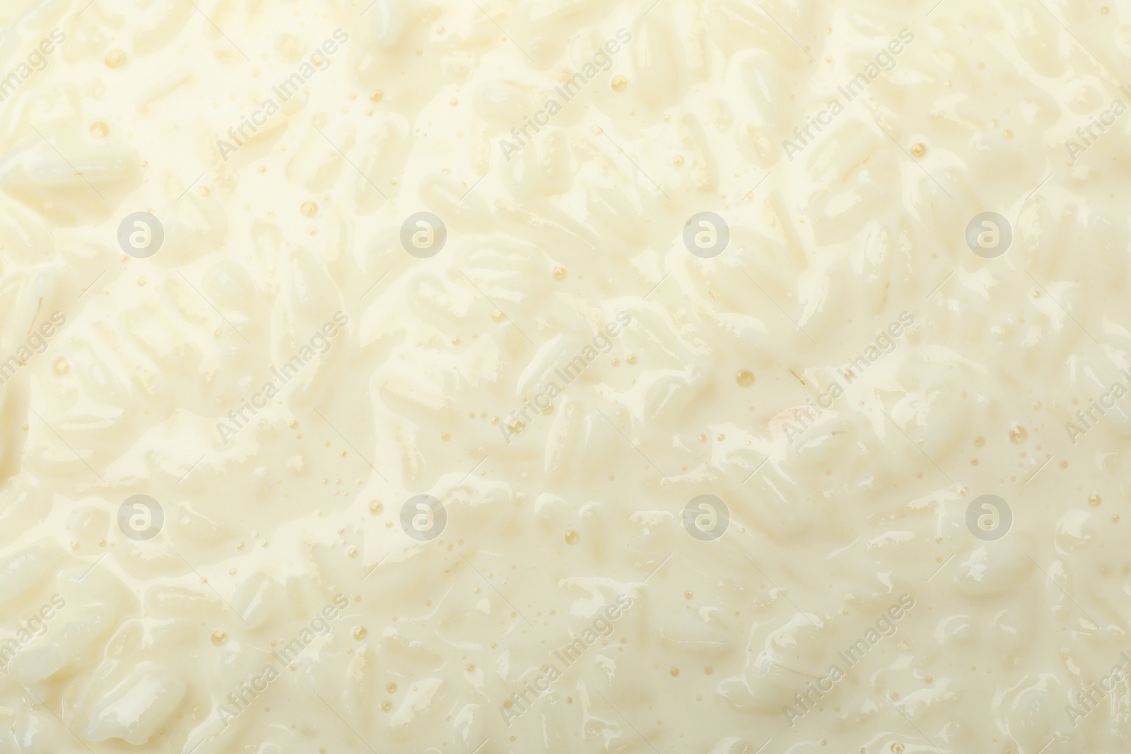 Photo of Delicious rice pudding as background, closeup view