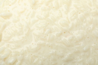 Photo of Delicious rice pudding as background, closeup view