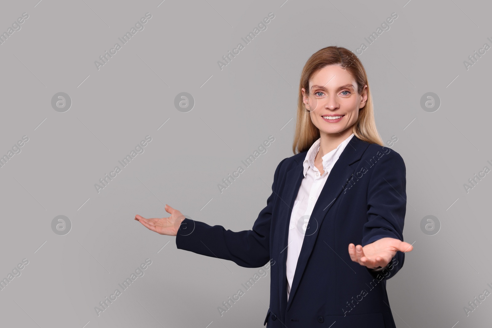 Photo of Happy real estate agent on grey background. Space for text