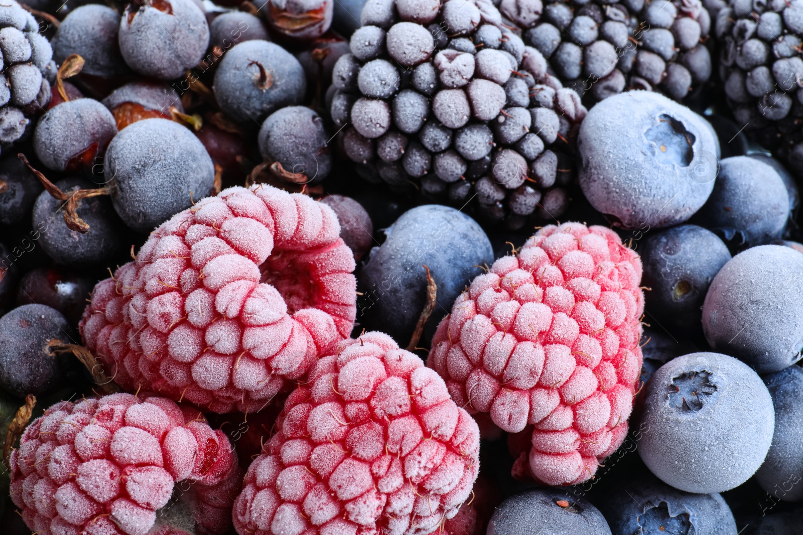 Photo of Mix of different frozen berries as background, top view