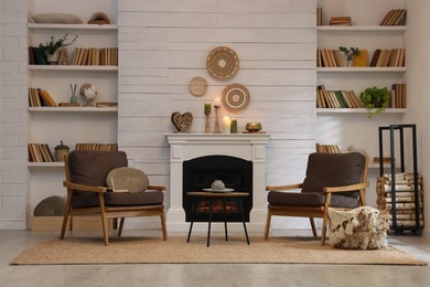 Cozy living room interior with comfortable armchairs near fireplace