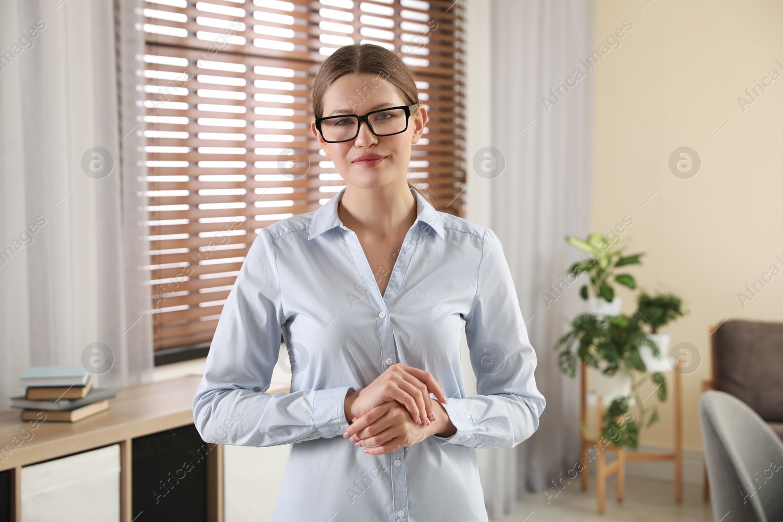 Photo of Professional psychotherapist with glasses in modern office