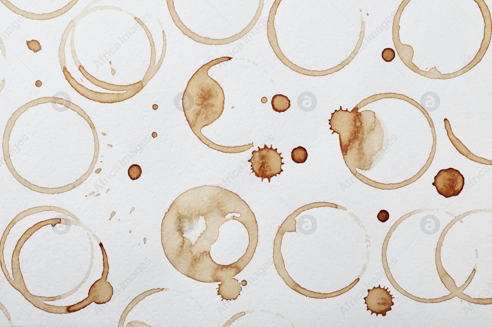 Photo of Dried coffee cup stains on white background, top view