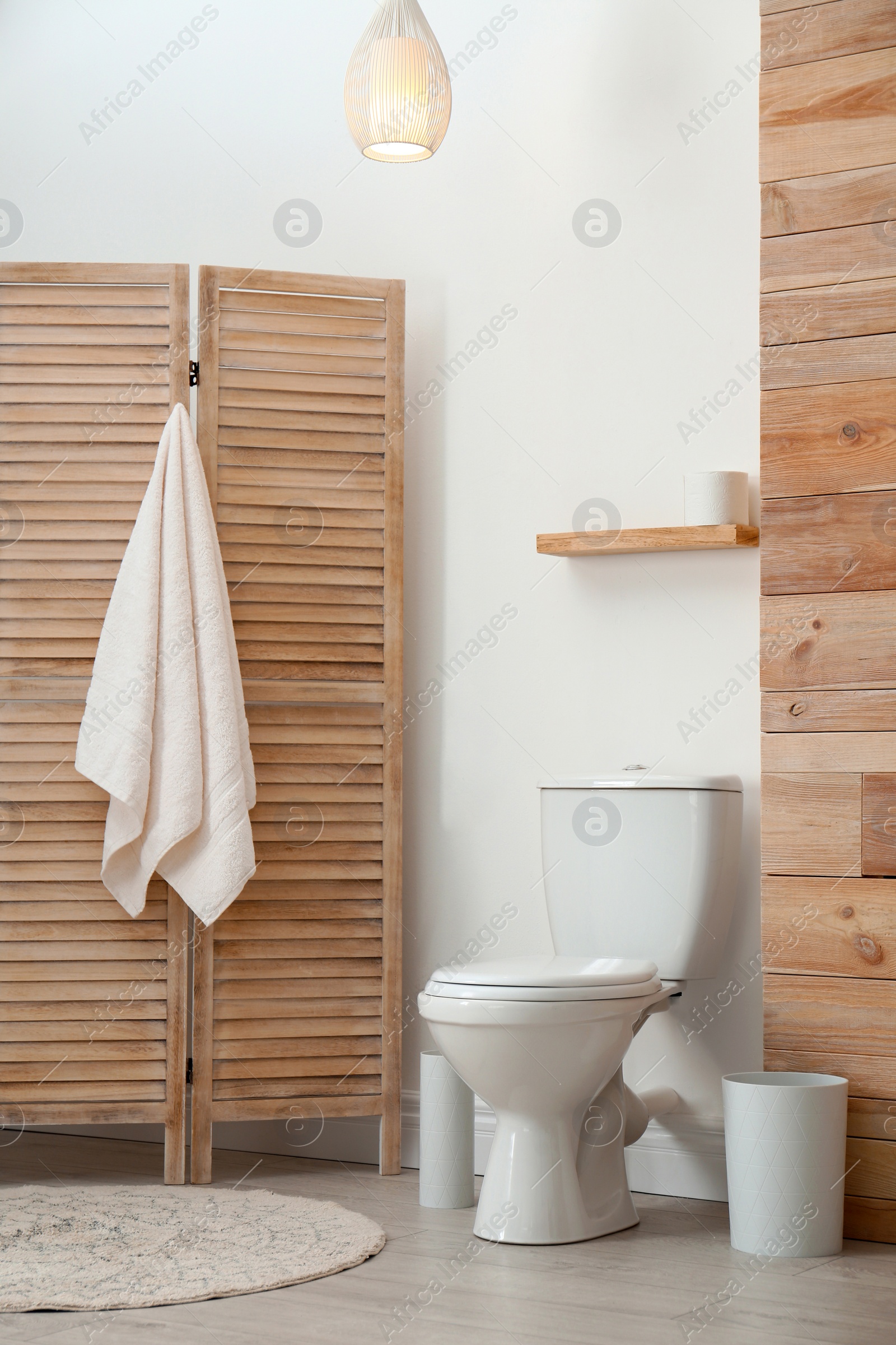 Photo of Toilet bowl near white wall in modern bathroom interior