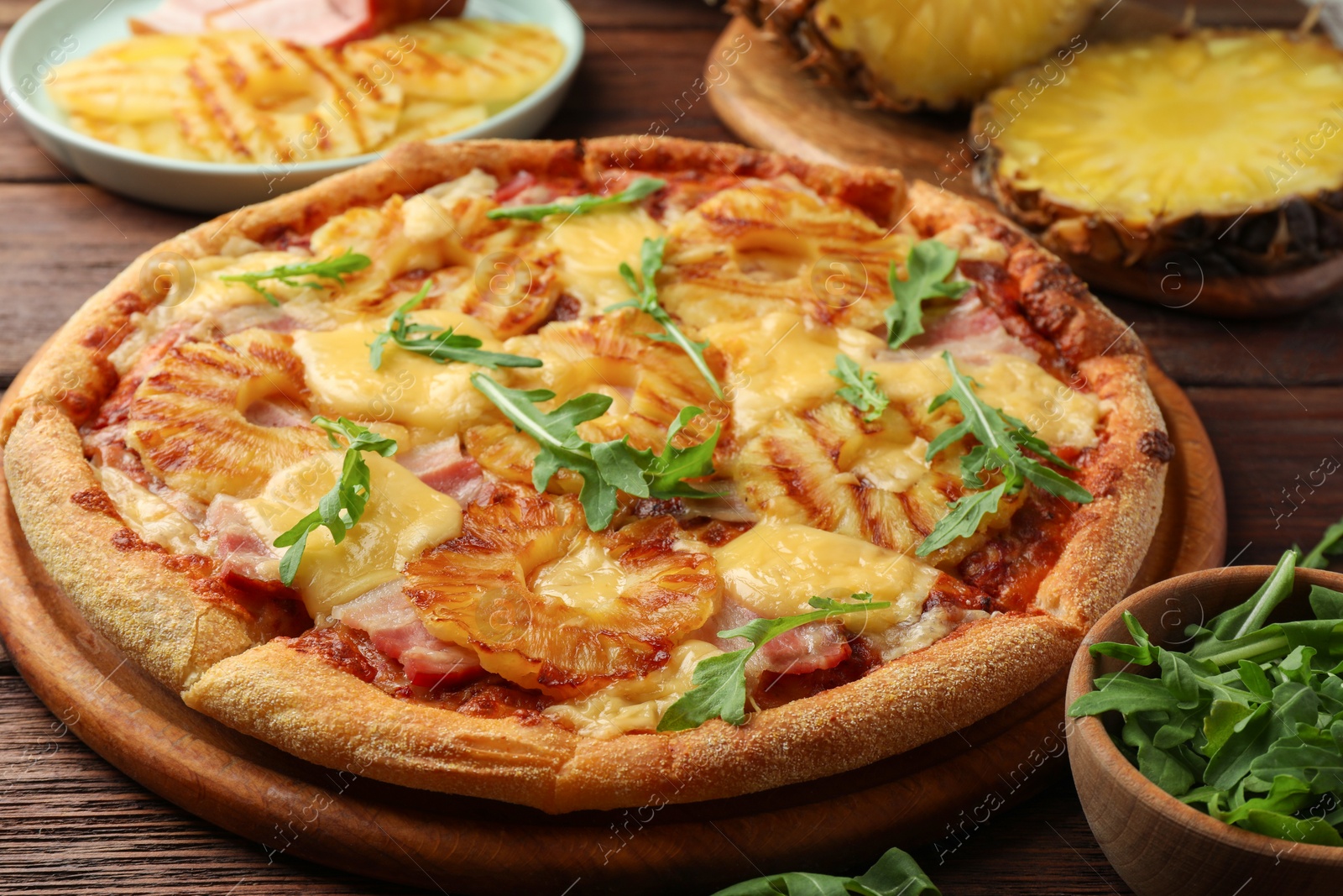 Photo of Delicious pineapple pizza with arugula on table, closeup