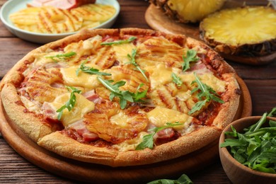 Photo of Delicious pineapple pizza with arugula on table, closeup