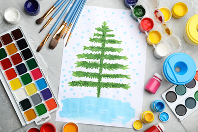 Flat lay composition with child's painting of fir tree on marble table
