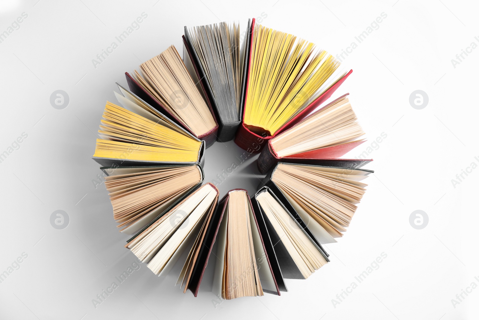 Photo of Circle made of hardcover books on white background, flat lay
