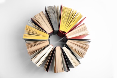 Photo of Circle made of hardcover books on white background, flat lay