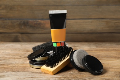Composition with shoe care accessories on wooden table