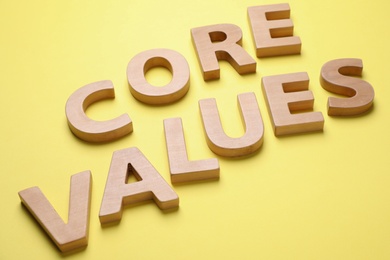 Phrase CORE VALUES made of wooden letters on yellow background