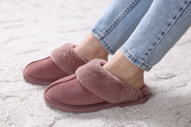 Photo of Woman in soft slippers at home, closeup