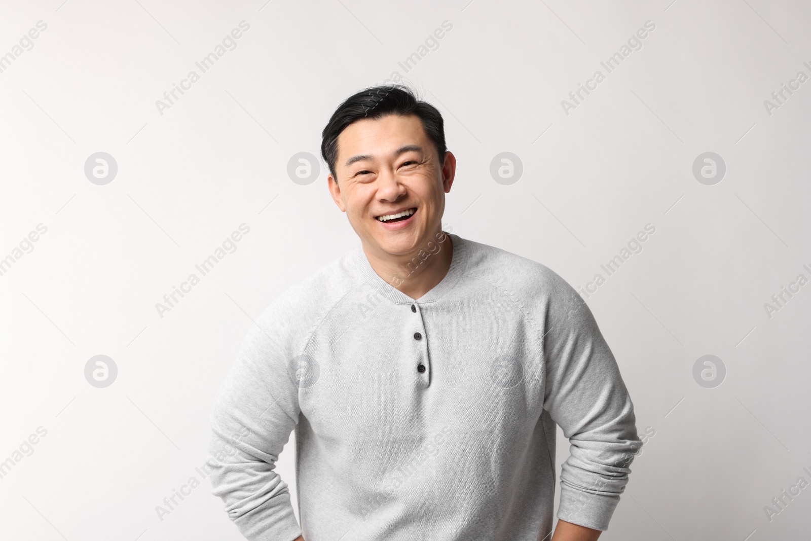 Photo of Portrait of happy man on light background