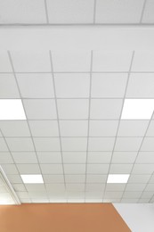 Photo of White ceiling in office room. Interior design