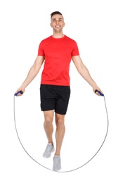 Photo of Full length portrait of young sportive man training with jump rope on white background