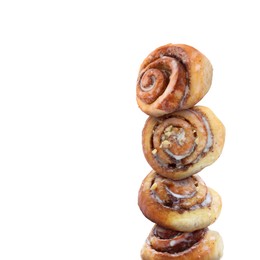 Fresh cinnamon rolls balancing on white background