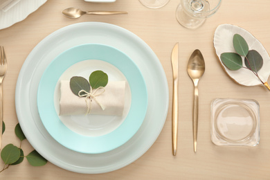 Photo of Elegant table setting with green leaves, flat lay
