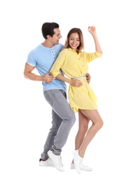 Beautiful young couple dancing on white background