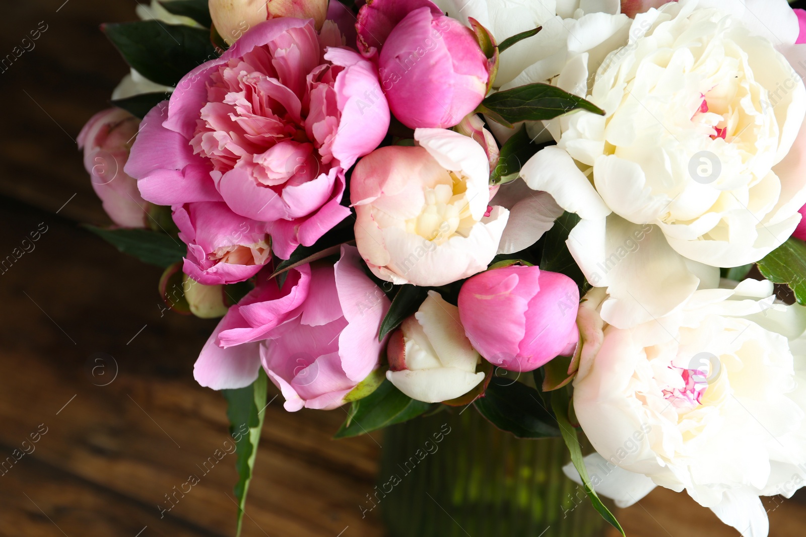 Photo of Bouquet of beautiful fresh peonies on wooden background, closeup