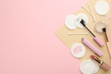 Photo of Dirty cotton pads, swabs and cosmetic products on color background, flat lay. Space for text