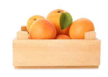 Wooden crate of delicious ripe sweet apricots isolated on white