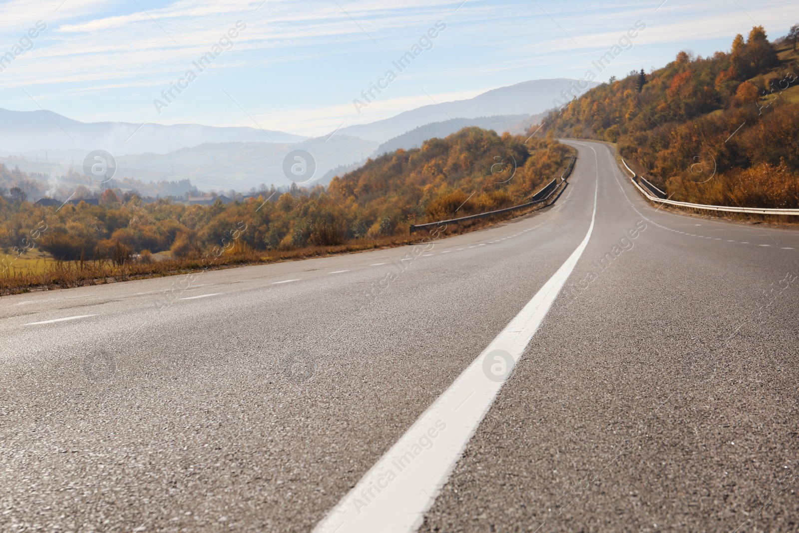 Photo of Landscape with asphalt road leading to mountains