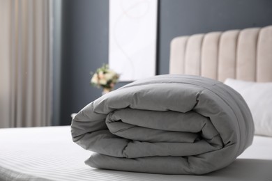 Photo of Soft folded blanket on bed at home