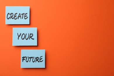 Photo of Motivational phrase Create Your Future made of sticky notes with words on orange background. Space for text