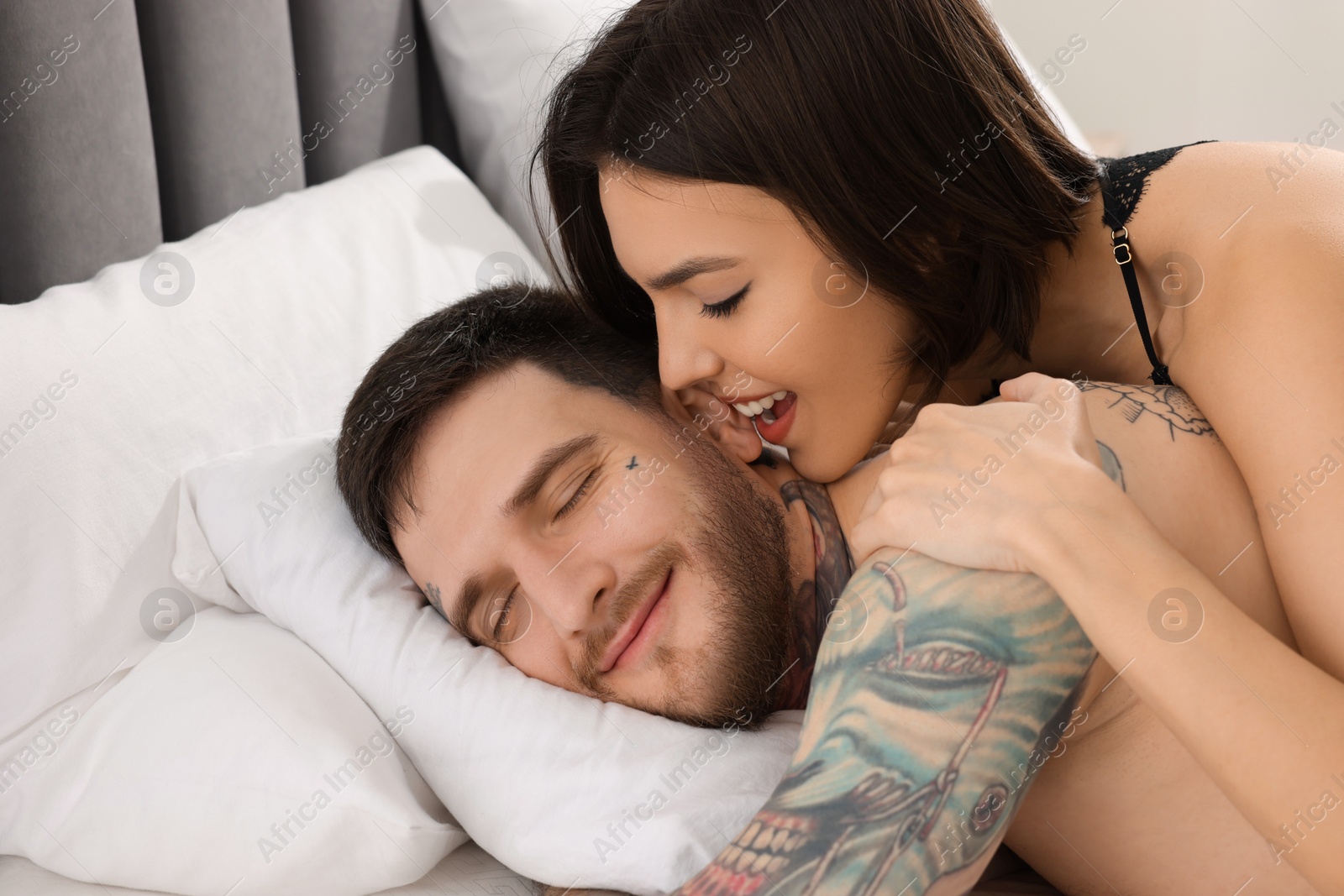 Photo of Passionate young couple having sex on bed