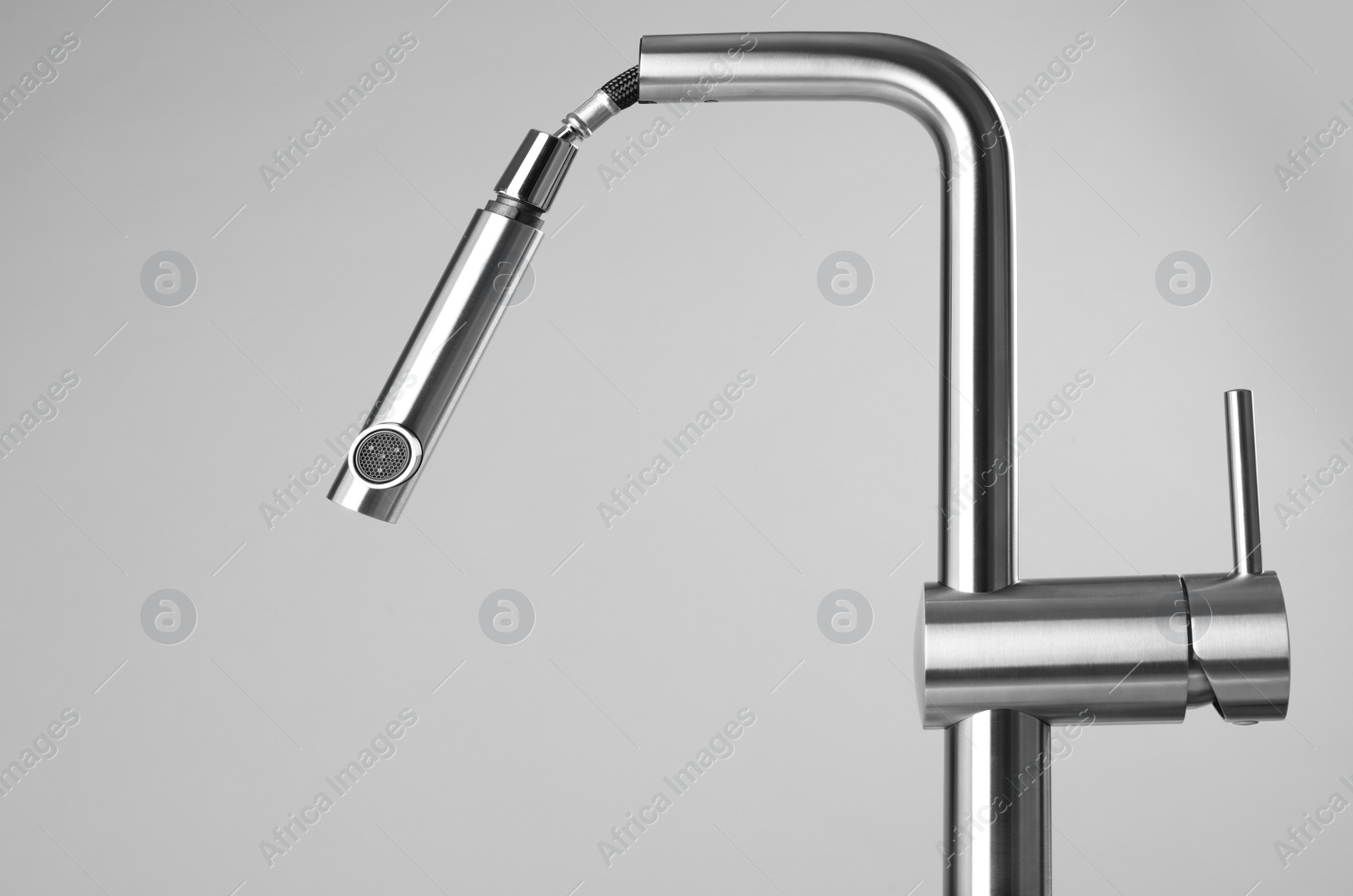 Photo of Modern pull out kitchen faucet on grey background