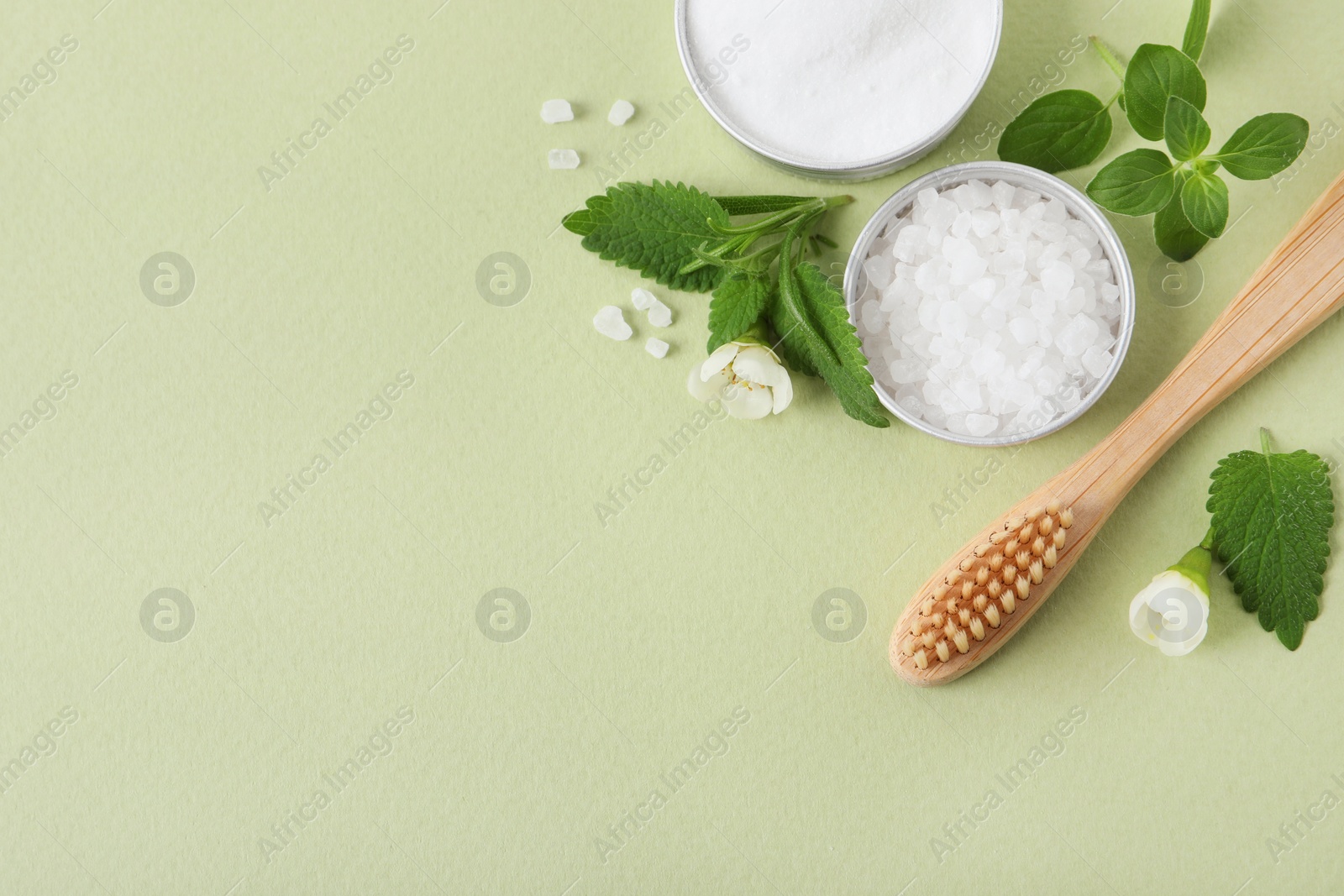 Photo of Flat lay composition with toothbrush and herbs on light olive background. Space for text