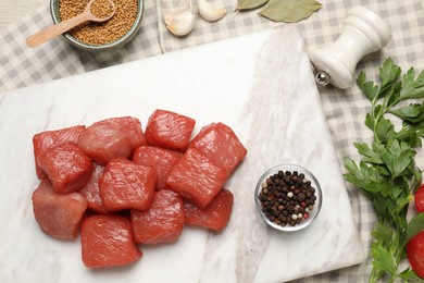 Photo of Raw beef meat and different ingredients for cooking delicious goulash on table, flat lay